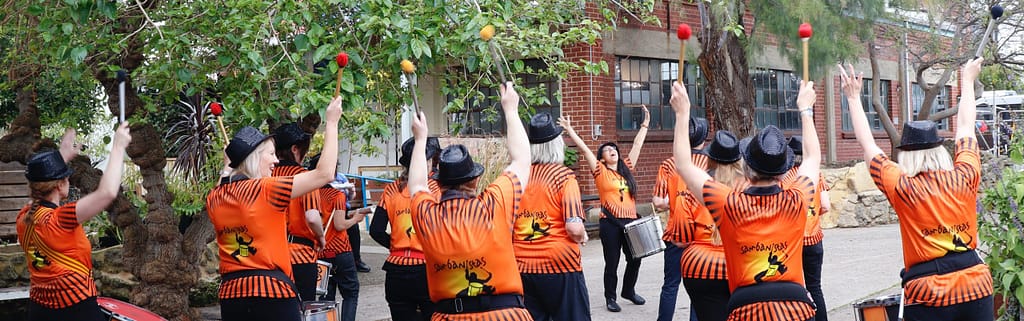 Samabanistas in Orange with their arms up cheering!